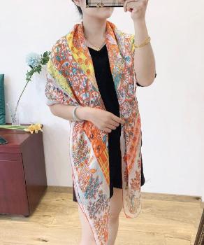 A woman wearing an orange sunflower silk chiffon scarf