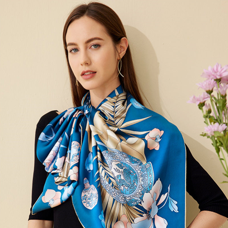 A lady wearing a blue  silk scarf