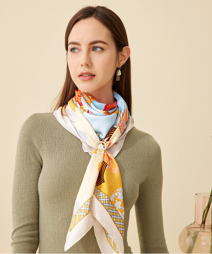 A lady wearing a silk square scarf